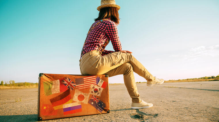 girl sitting on a luggage