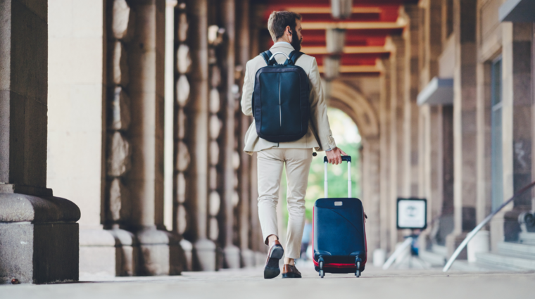 a man with a backpack and a suitcase