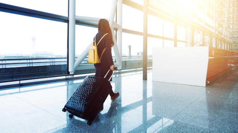 a woman with luggage at the airport